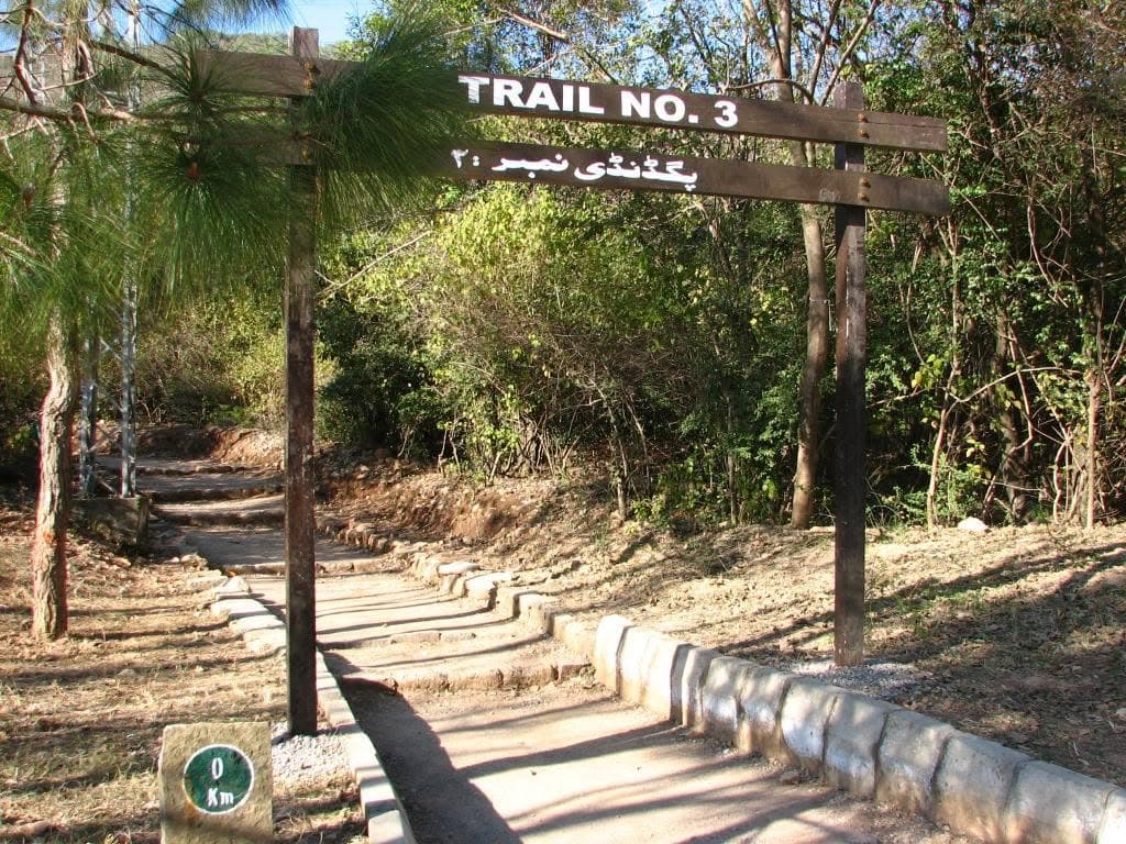 The Trail 3 trailhead gate on Margalla Road, with the trail's 0 km marker at its foot.